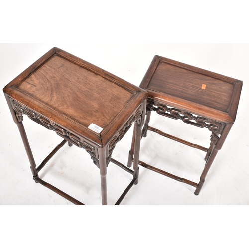 669 - A 19th century Chinese Oriental padauk wood nest of two graduating tables. Each table having a reces... 