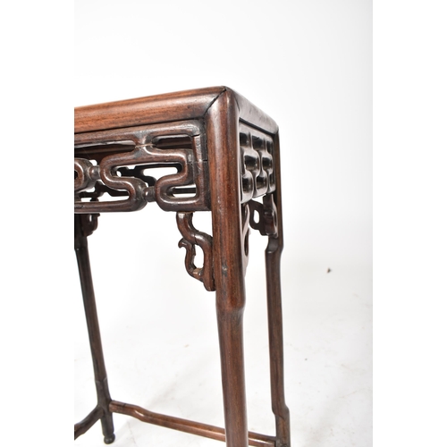 669 - A 19th century Chinese Oriental padauk wood nest of two graduating tables. Each table having a reces... 