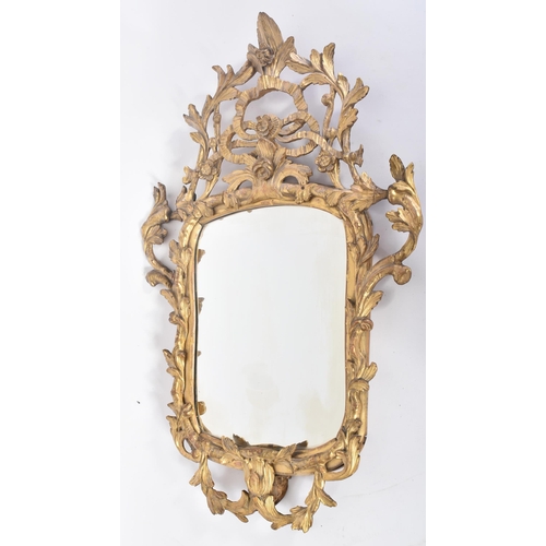 68 - An 18th century George II giltwood and gesso carved mirror. The mirror having a central mirror plate... 