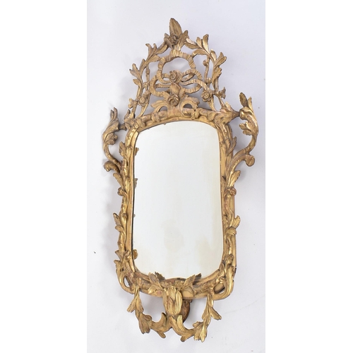 68 - An 18th century George II giltwood and gesso carved mirror. The mirror having a central mirror plate... 