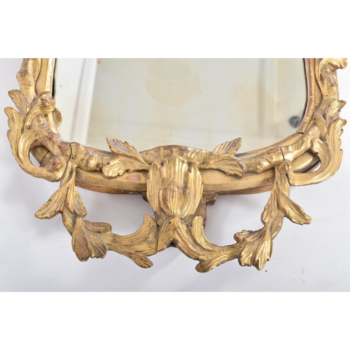 68 - An 18th century George II giltwood and gesso carved mirror. The mirror having a central mirror plate... 