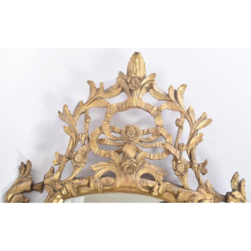 68 - An 18th century George II giltwood and gesso carved mirror. The mirror having a central mirror plate... 