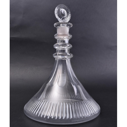 71 - An early 19th century George III cut glass ships decanter with stopper. The stopper of target form w... 