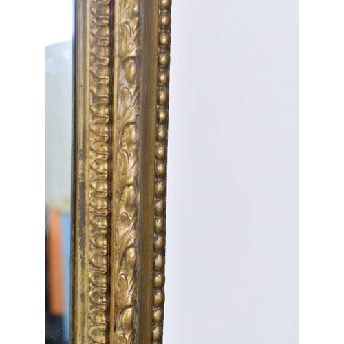 79 - A large Victorian 19th century gilt wood & gesso over mantle mirror. The mirror having an intricate ... 