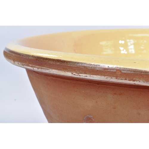 85 - An early 20th century large earthenware terracotta glazed milking / dairy bowl. Terracotta construct... 