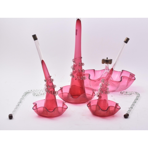 88 - A late 19th century cranberry glass table epergne centrepiece decoration. The centrepiece comprising... 