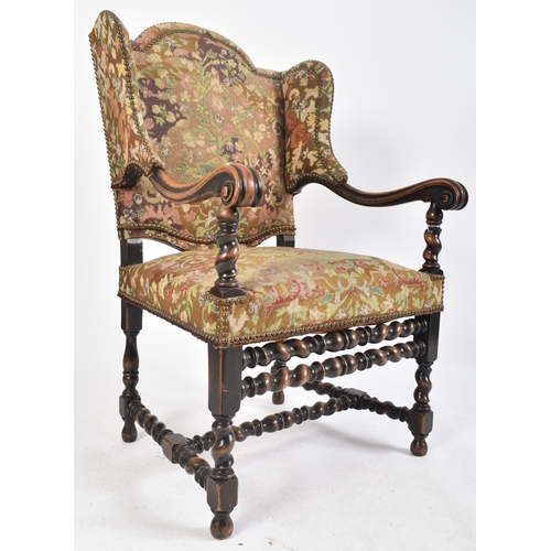 92 - A 19th century French Louis XIV style oak framed wing back tapestry armchair. The arm chair having a... 