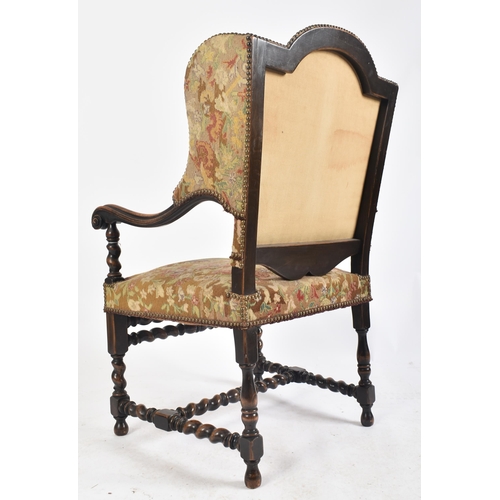 92 - A 19th century French Louis XIV style oak framed wing back tapestry armchair. The arm chair having a... 