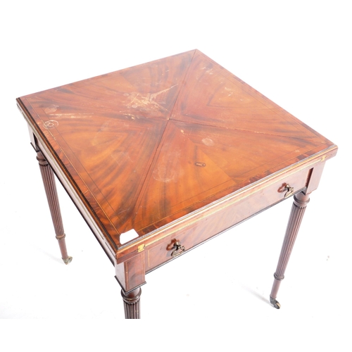 271 - A 19th century flame mahogany and boxwood inlaid envelope card / games table. The table having a fou... 