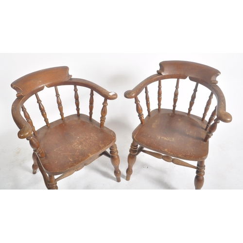 374 - A pair of Victorian 19th century beech and elm wood smokers bow captain's armchairs. The armchairs h... 