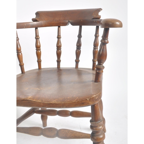 374 - A pair of Victorian 19th century beech and elm wood smokers bow captain's armchairs. The armchairs h... 