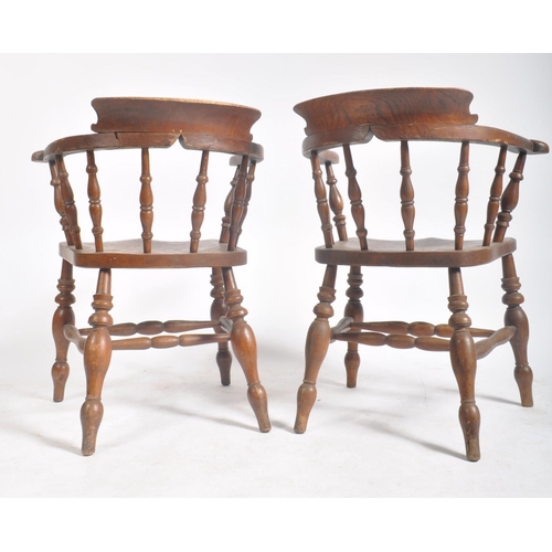 374 - A pair of Victorian 19th century beech and elm wood smokers bow captain's armchairs. The armchairs h... 