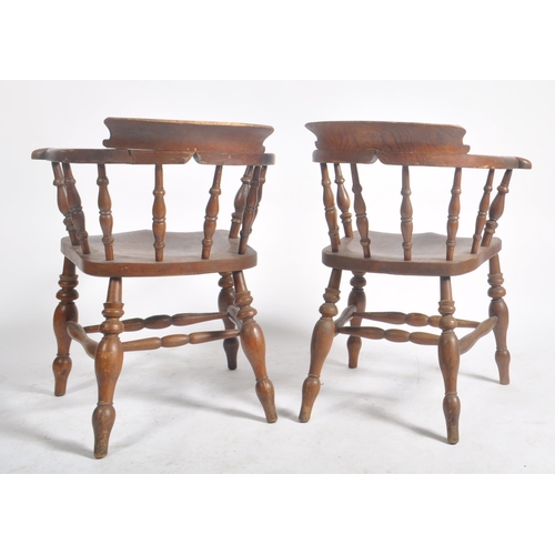 374 - A pair of Victorian 19th century beech and elm wood smokers bow captain's armchairs. The armchairs h... 