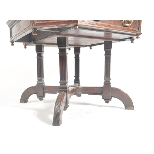 396 - A Victorian late 19th century circa 1880s flame mahogany rent octagonal table desk. The table having... 