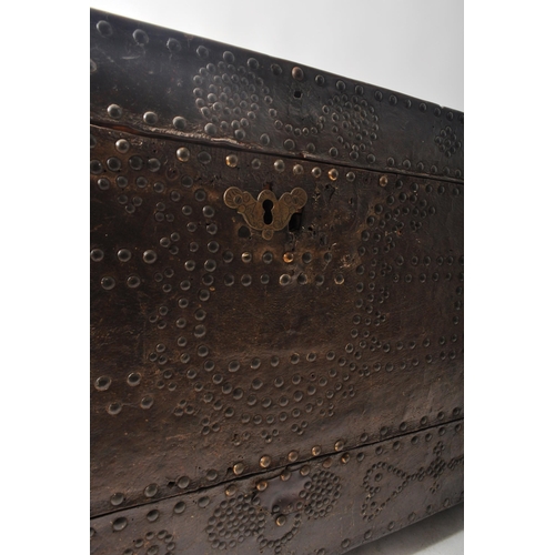 416 - A 17th Century James II oak and leather bound coffer chest. The leather bound and stud worked oak ch... 