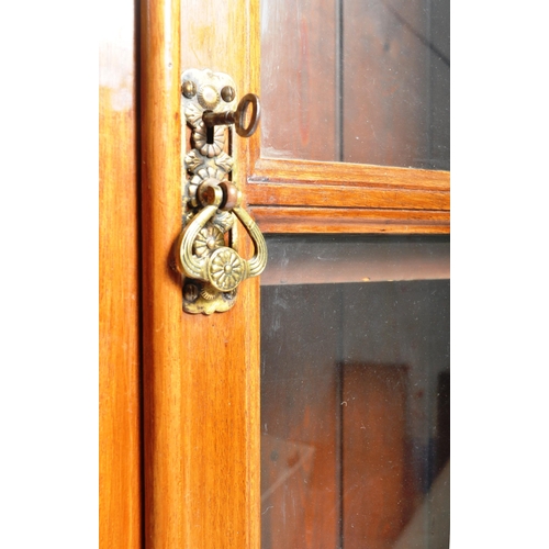 463 - A Victorian 19th century flame mahogany glazed bookcase library cabinet. The cabinet having a rectan... 