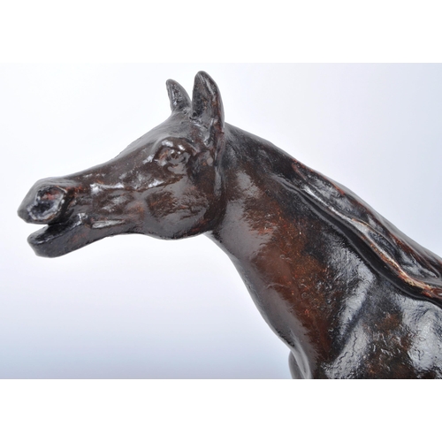 666 - A 20th century plaster study of a horse in motion. The horse painted with a bronze finish and mounte... 