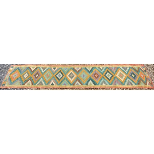 269 - A 20th century Anatolian Turkish Islamic Kilim hand woven floor carpet runner rug. The rug having a ... 