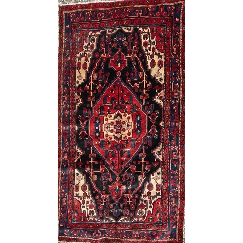 319 - An early 20th century North West Persian Islamic Nahawand hand woven floor carpet rug. The rug havin... 