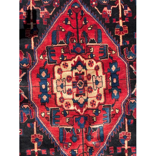 319 - An early 20th century North West Persian Islamic Nahawand hand woven floor carpet rug. The rug havin... 