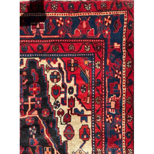 319 - An early 20th century North West Persian Islamic Nahawand hand woven floor carpet rug. The rug havin... 