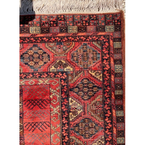 399 - An early 20th century Persian Islamic Bukhara hand woven floor carpet rug. The rug having two centra... 