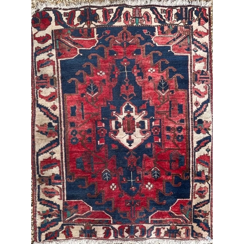 433 - An early 20th century Persian Islamic Hamadan hand woven floor carpet rug. The rug having central re... 