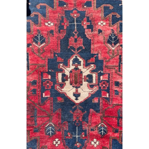 433 - An early 20th century Persian Islamic Hamadan hand woven floor carpet rug. The rug having central re... 