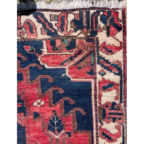 433 - An early 20th century Persian Islamic Hamadan hand woven floor carpet rug. The rug having central re... 