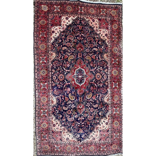 41 - A 19th century North West Persian Islamic Sarouk hand woven floor carpet rug, having a cobalt medall... 