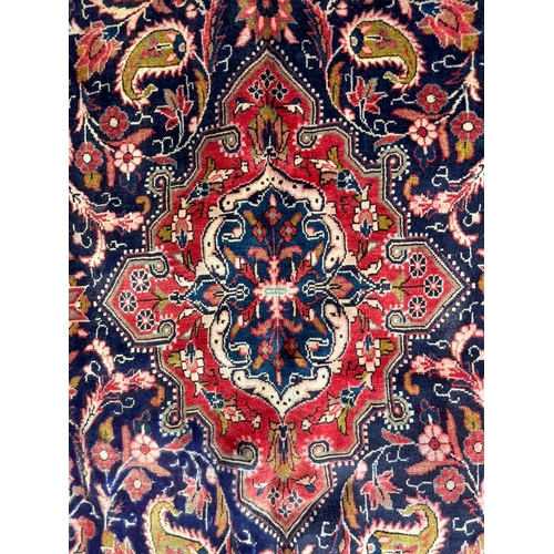 41 - A 19th century North West Persian Islamic Sarouk hand woven floor carpet rug, having a cobalt medall... 