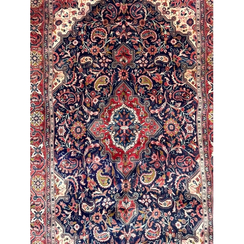 41 - A 19th century North West Persian Islamic Sarouk hand woven floor carpet rug, having a cobalt medall... 