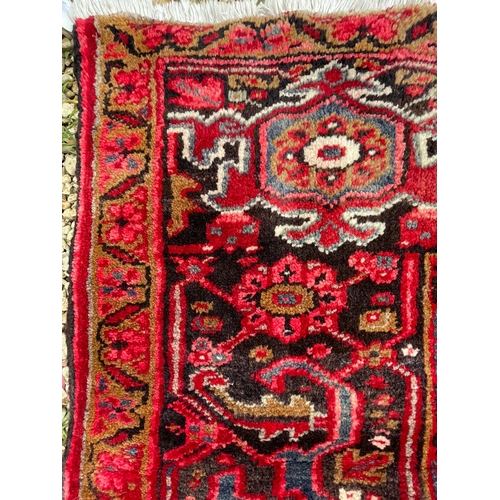 264 - A 19th century Central Persian Islamic Heriz hand woven floor carpet rug, having a central panel wit... 