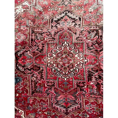 264 - A 19th century Central Persian Islamic Heriz hand woven floor carpet rug, having a central panel wit... 