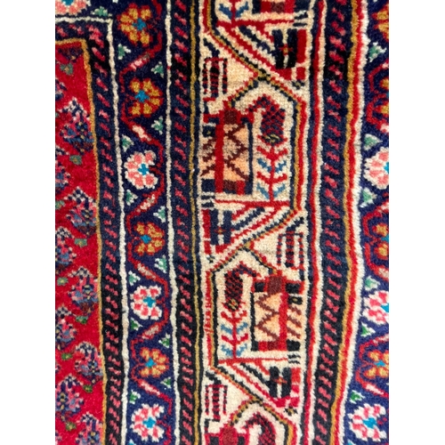 394 - An early 20th century North West Persian Islamic Mir Kelleh hand woven floor carpet rug having a cen... 