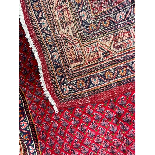 394 - An early 20th century North West Persian Islamic Mir Kelleh hand woven floor carpet rug having a cen... 