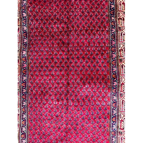 394 - An early 20th century North West Persian Islamic Mir Kelleh hand woven floor carpet rug having a cen... 