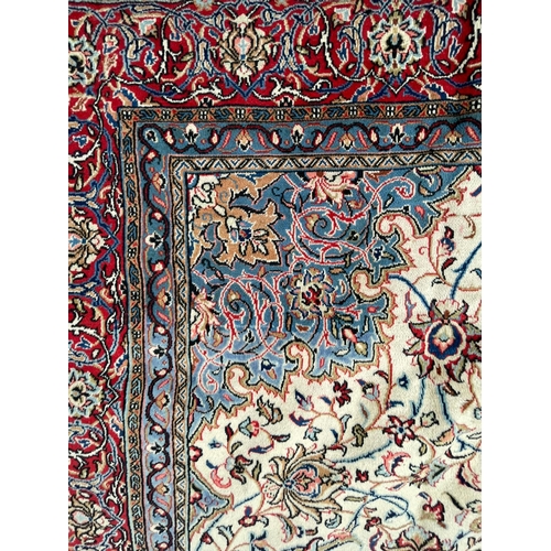 444 - An early 20th century North West Persian Islamic Sarouk hand woven floor carpet rug having a central... 