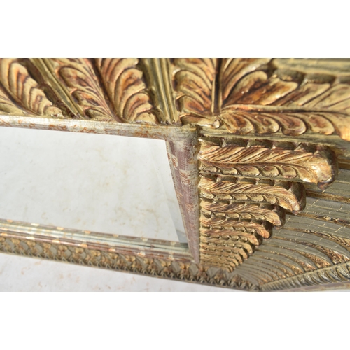 125 - A large 20th century Regency Revival resin wall hanging hall mirror. The mirror having a bevelled fr... 