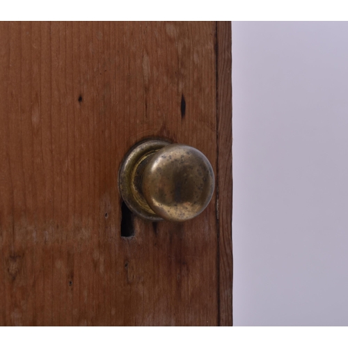 143 - A late 19th century Victorian pine pigeon hole cupboard. The cupboard having a single full length do... 