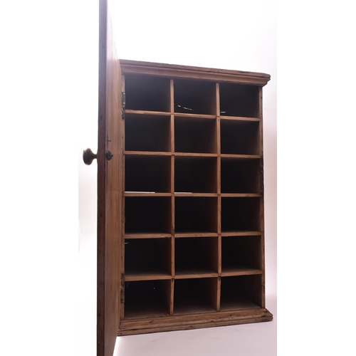 143 - A late 19th century Victorian pine pigeon hole cupboard. The cupboard having a single full length do... 