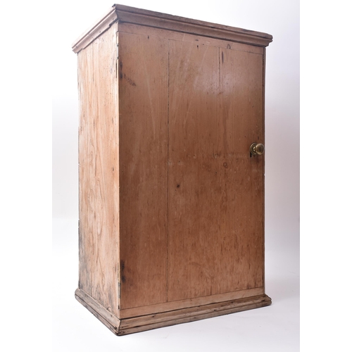 143 - A late 19th century Victorian pine pigeon hole cupboard. The cupboard having a single full length do... 