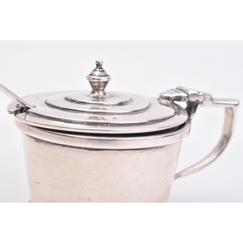 145 - A hallmarked silver lidded mustard pot with glass liner and spoon. The mustard pot of graduating cir... 