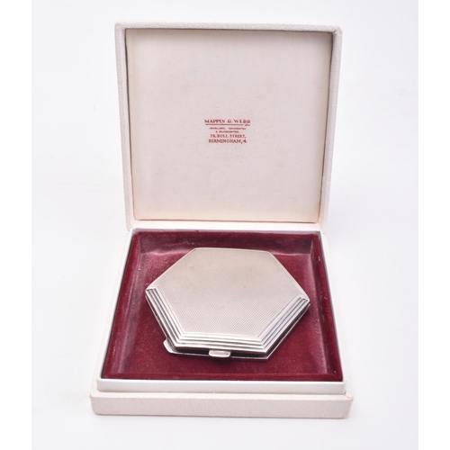 39 - A hallmarked silver compact mirror. The mirror of post war Art Deco style in hexagonal form with ste... 