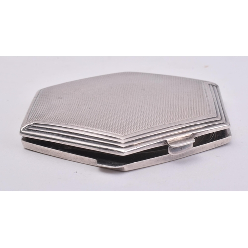 39 - A hallmarked silver compact mirror. The mirror of post war Art Deco style in hexagonal form with ste... 