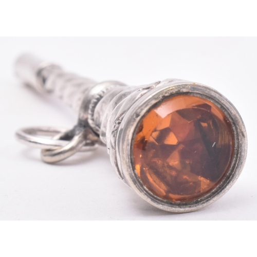 89 - A silver plated orange paste pocket watch key fob. The pocket watch key of twisted and etched form h... 