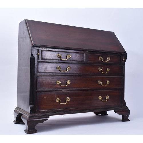 138 - A miniature George III style mahogany bureau. The Bureau desk having a fall front top section with f... 