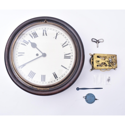 634 - An early 20th century mahogany cased station wall clock. The clock having a white enamel face with R... 