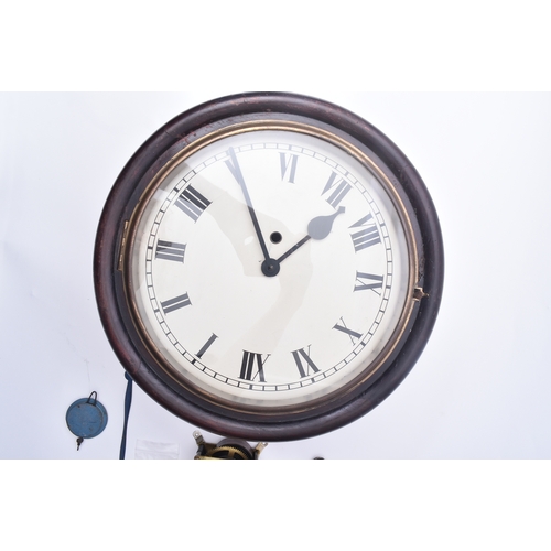 634 - An early 20th century mahogany cased station wall clock. The clock having a white enamel face with R... 