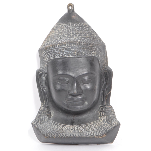 249 - A 20th Century cast ebonised brass Khmer Cambodian Buddha deity wall face mask, with detailed facial... 